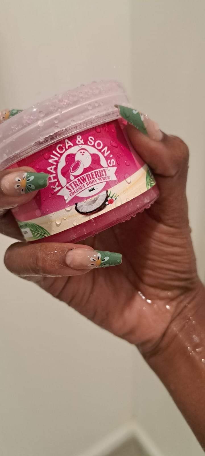 Jar of coconut sugar body scrub with a spoon resting on top